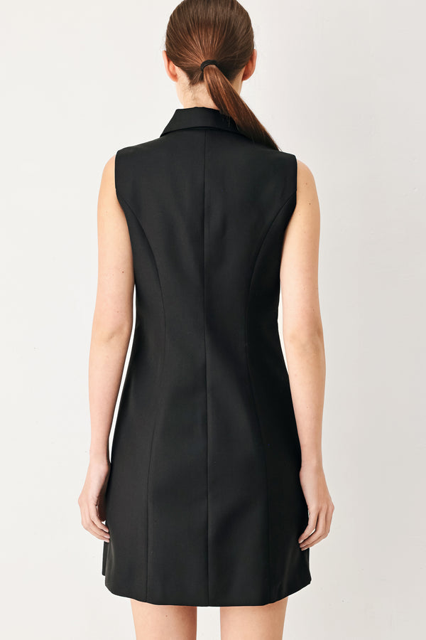 Woman wearing a black sleeveless mini dress featuring blazer collar and front button down | FREEMARKET
