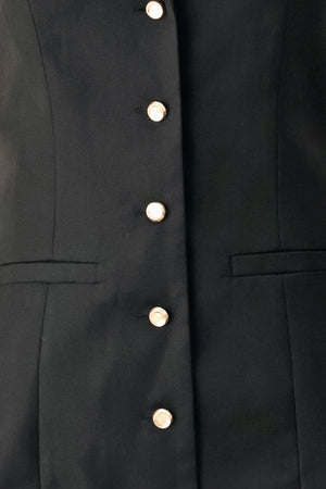 Woman wearing a black sleeveless mini dress featuring blazer collar and front button down | FREEMARKET