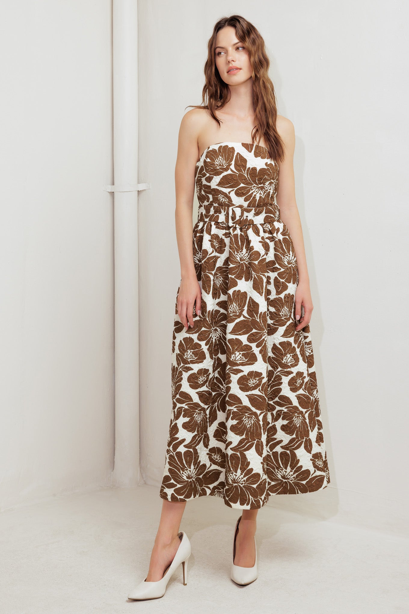 A textured printed woven midi dress featuring strapless, self belt, full skirt and back zipper closure