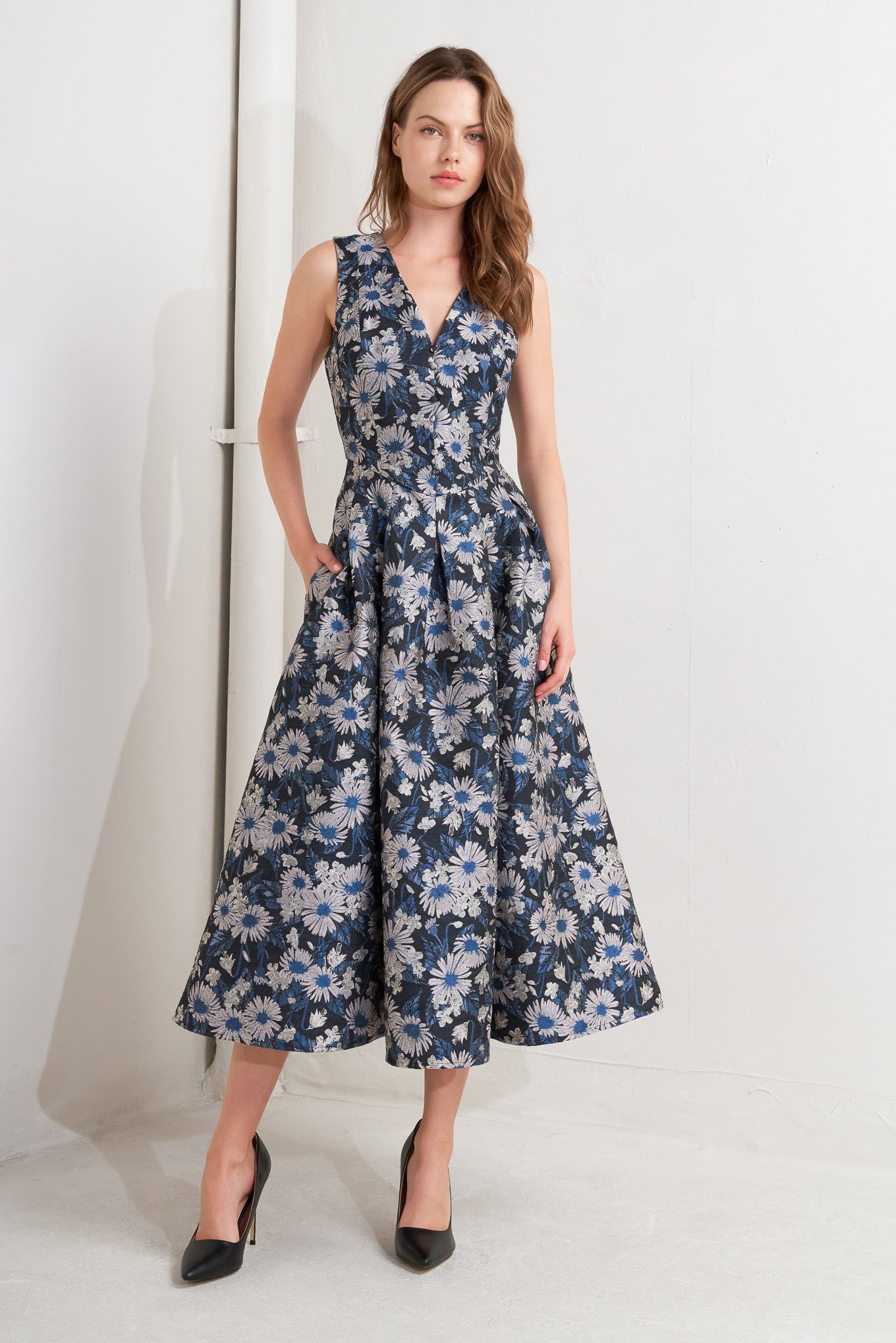 A woven jacquard midi dress featuring V neckline, sleeveless, front button detail and back zipper closure
