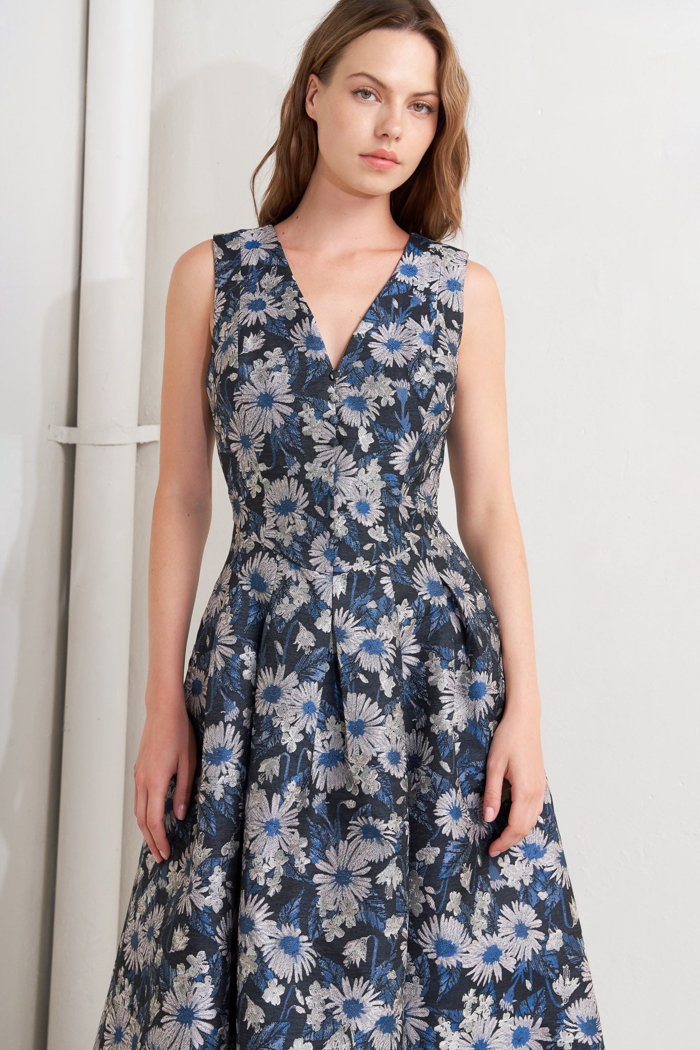 A woven jacquard midi dress featuring V neckline, sleeveless, front button detail and back zipper closure