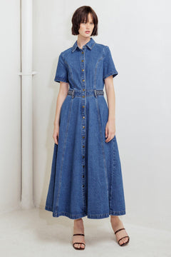 A washed denim midi dress featuring collar, short sleeve, button down, braided waistband and circle skirt