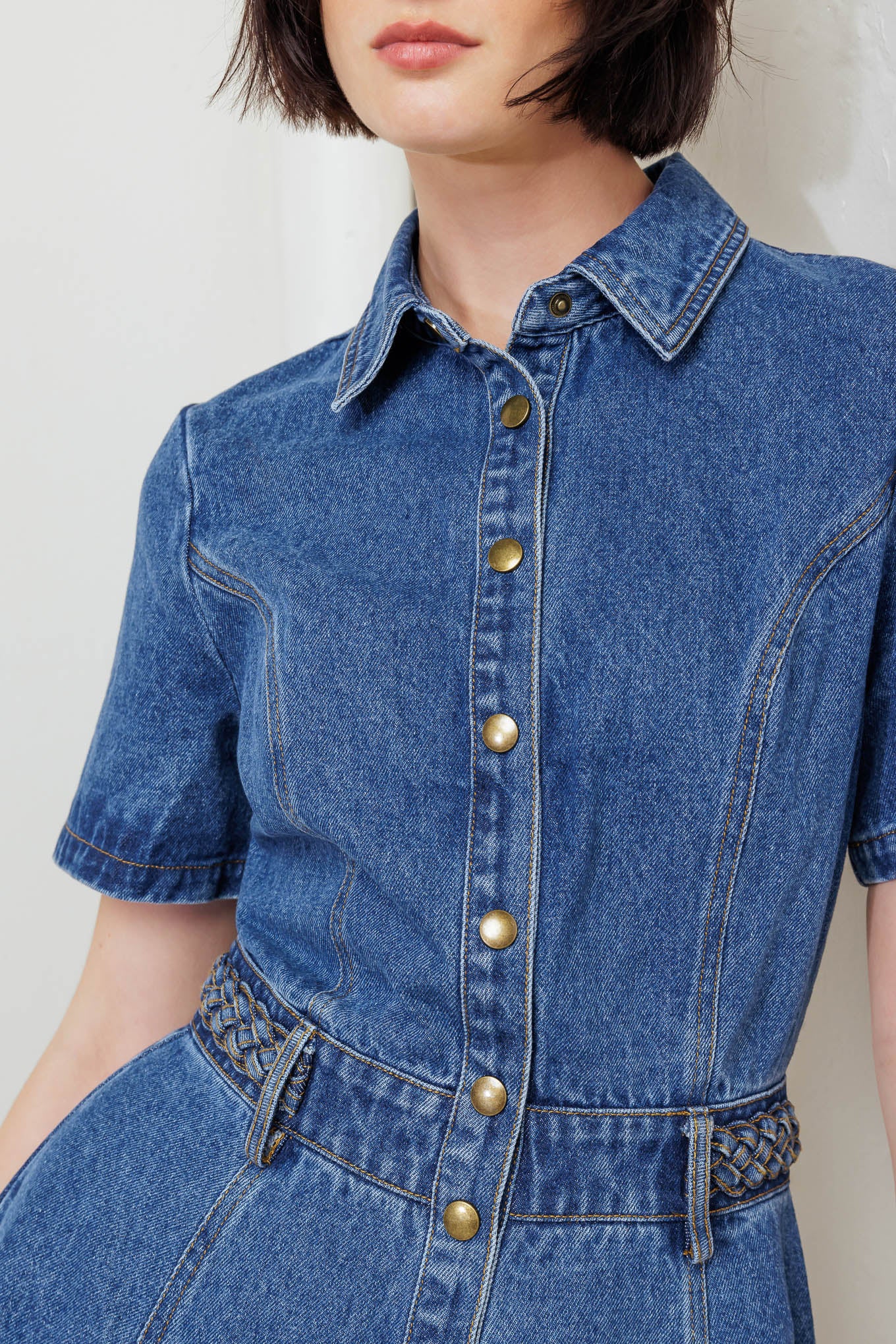 A washed denim midi dress featuring collar, short sleeve, button down, braided waistband and circle skirt