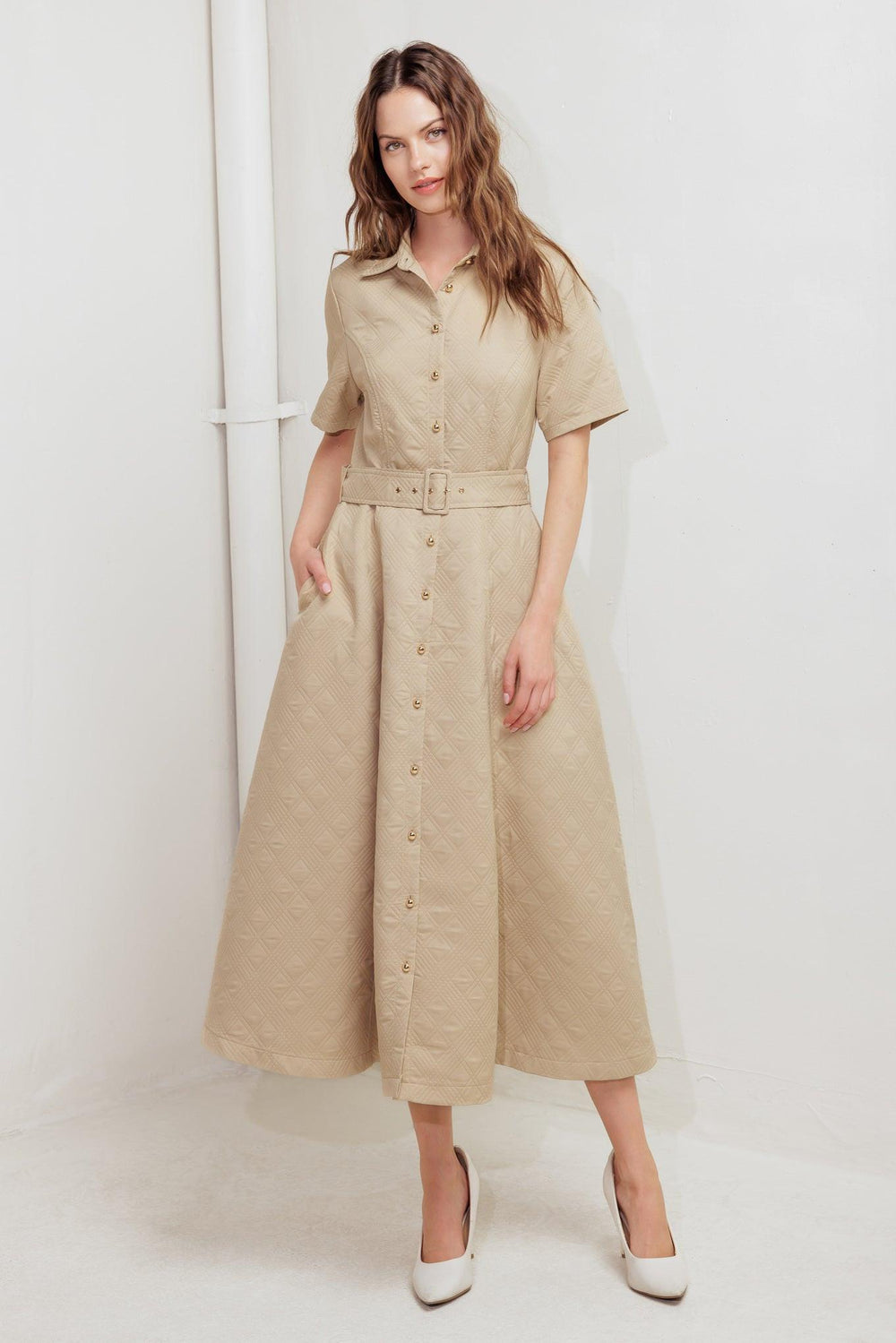 A textured woven midi dress featuring collar, short sleeve, button down, self belt and circle skirt