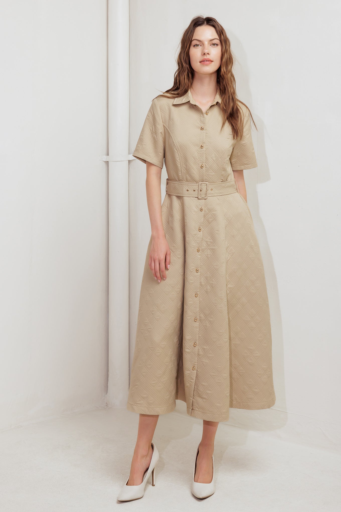A textured woven midi dress featuring collar, short sleeve, button down, self belt and circle skirt