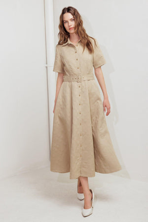 A textured woven midi dress featuring a collar, short sleeve, button down, self belt and circle skirt