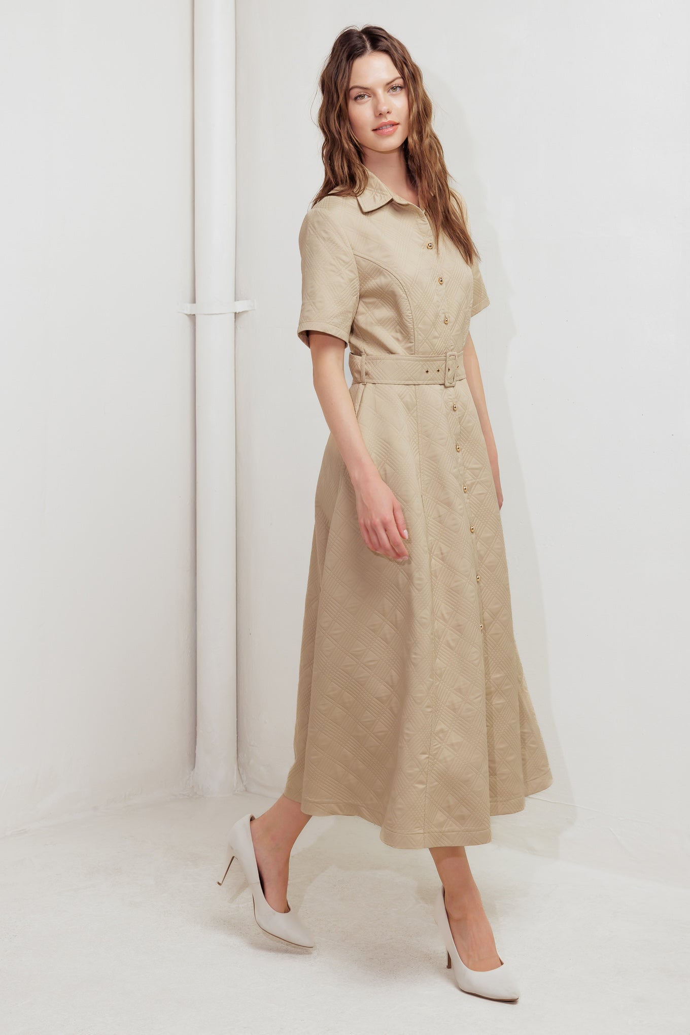 A textured woven midi dress featuring collar, short sleeve, button down, self belt and circle skirt
