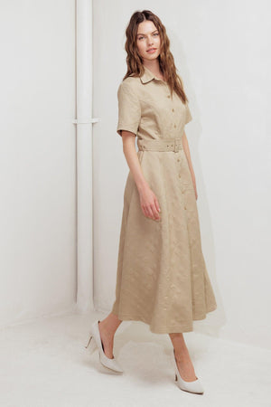 A textured woven midi dress featuring collar, short sleeve, button down, self belt and circle skirt