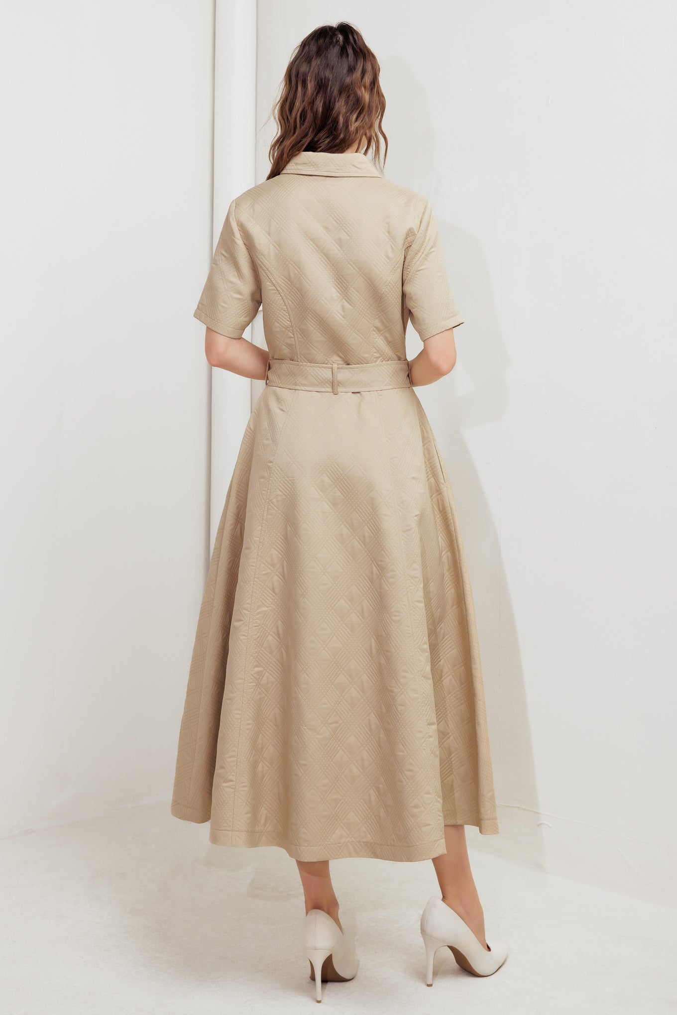 A textured woven midi dress featuring collar, short sleeve, button down, self belt and circle skirt