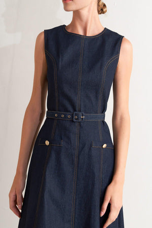 A denim midi dress featuring round neckline, sleeveless, self belt, circle skirt and back zipper closure