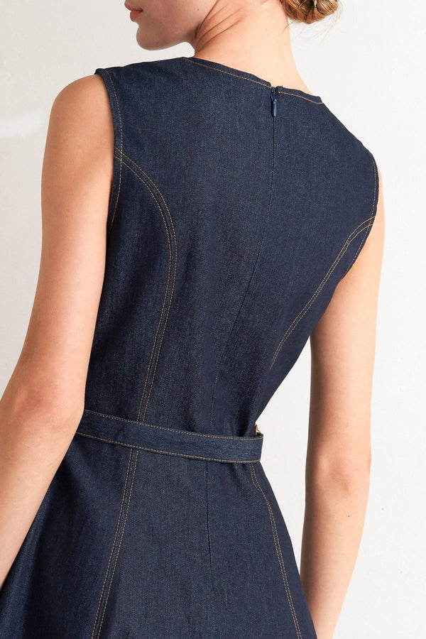 A denim midi dress featuring round neckline, sleeveless, self belt, circle skirt and back zipper closure