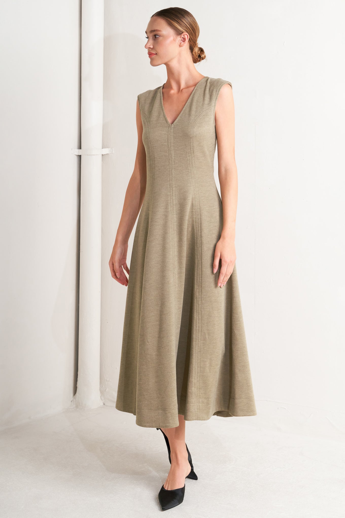 A woven knit midi dress featuring V neckline, sleeveless, circle skirt and back zipper closure