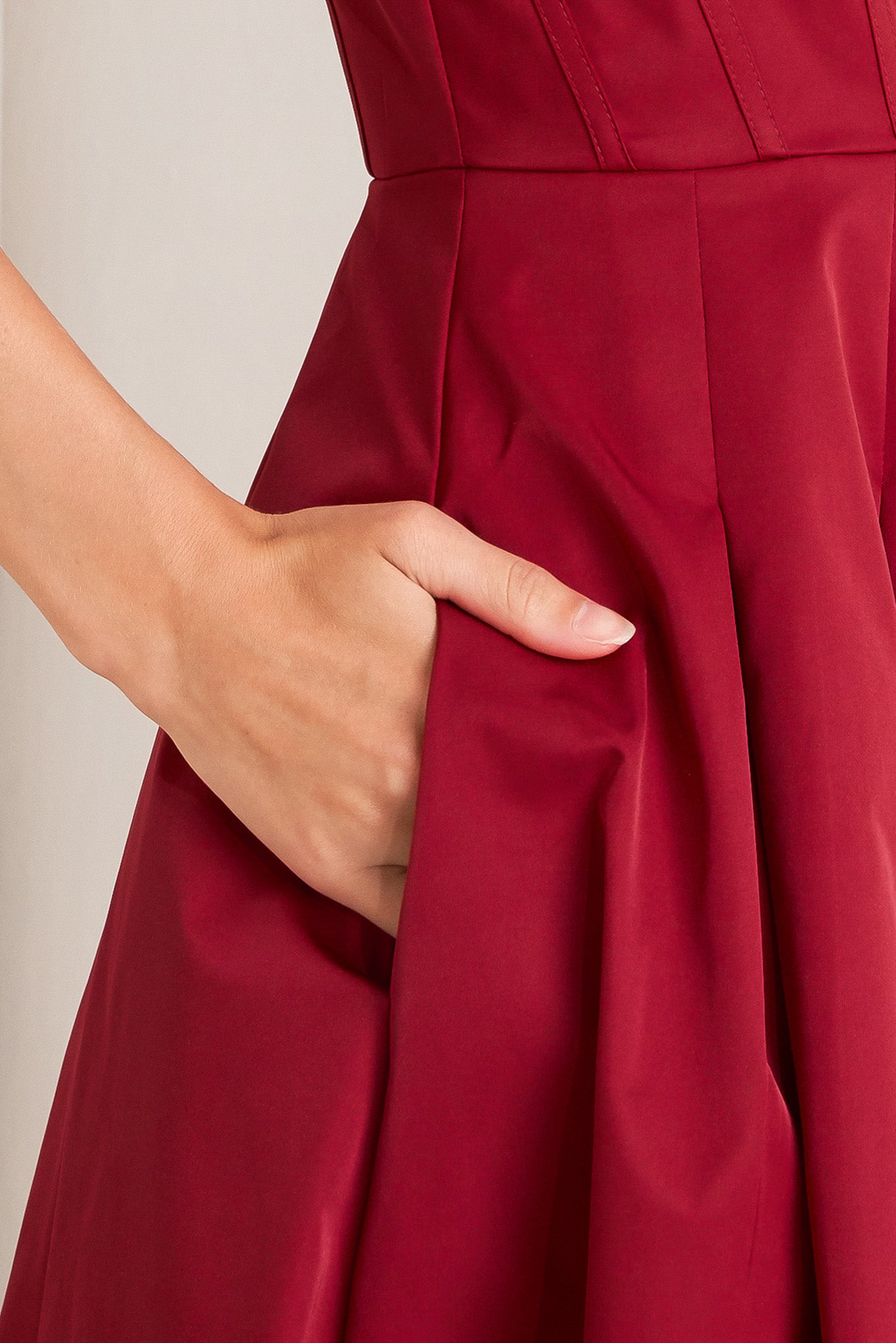 A solid woven midi dress featuring U neckline, straps, full skirt and back zipper closure