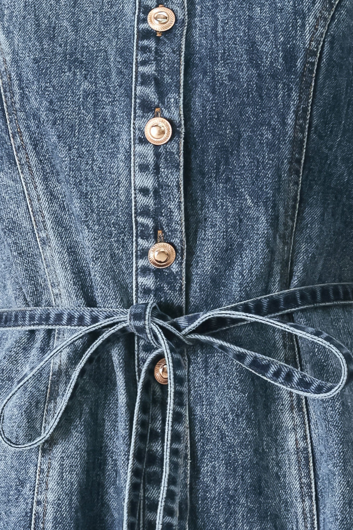Close up of a denim mini dress featuring front button down, short sleeve and skinny waist tie | FREEMARKET
