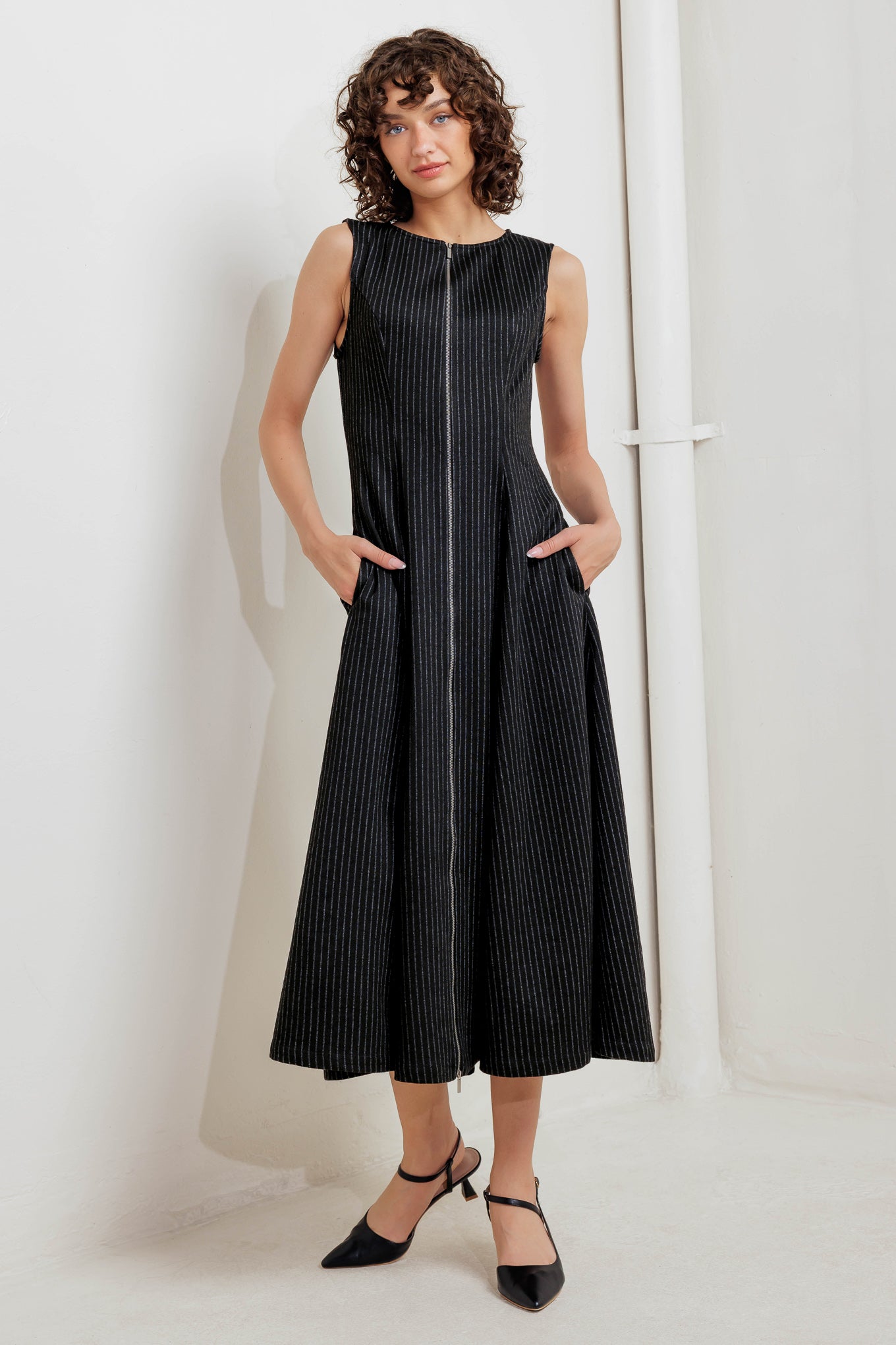 A striped woven midi dress featuring round neckline, sleeveless, circle skirt and front zipper closure