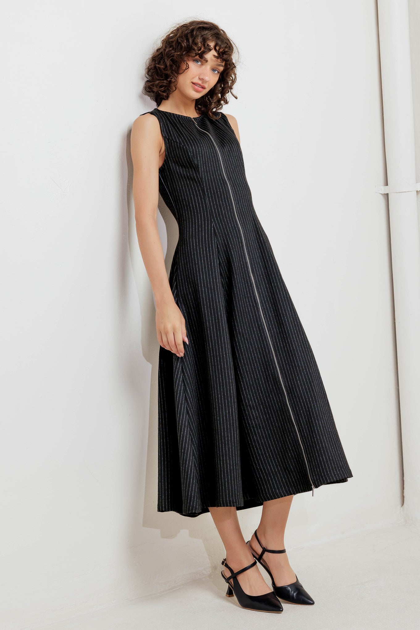 A striped woven midi dress featuring round neckline, sleeveless, circle skirt and front zipper closure
