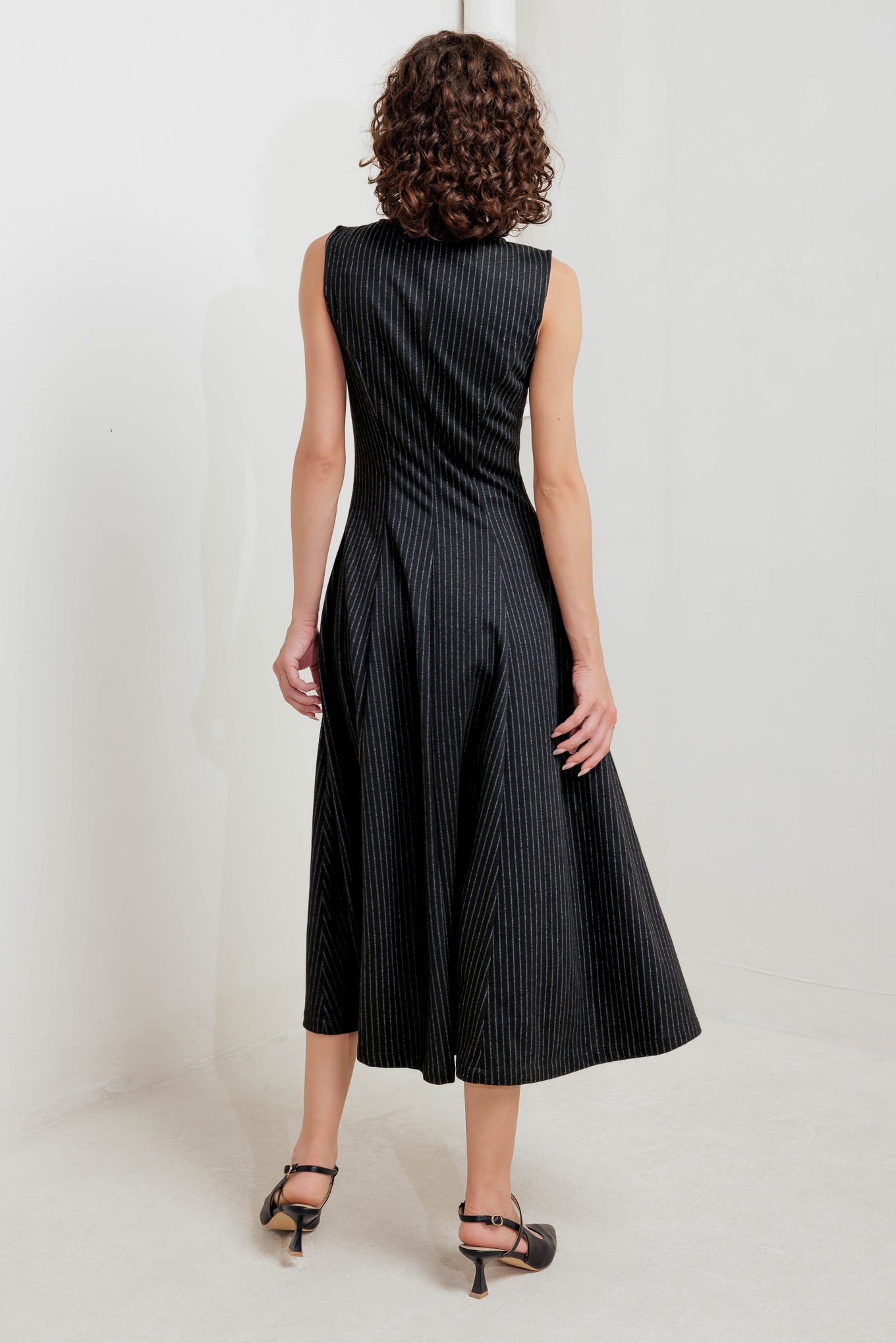 A striped woven midi dress featuring round neckline, sleeveless, circle skirt and front zipper closure
