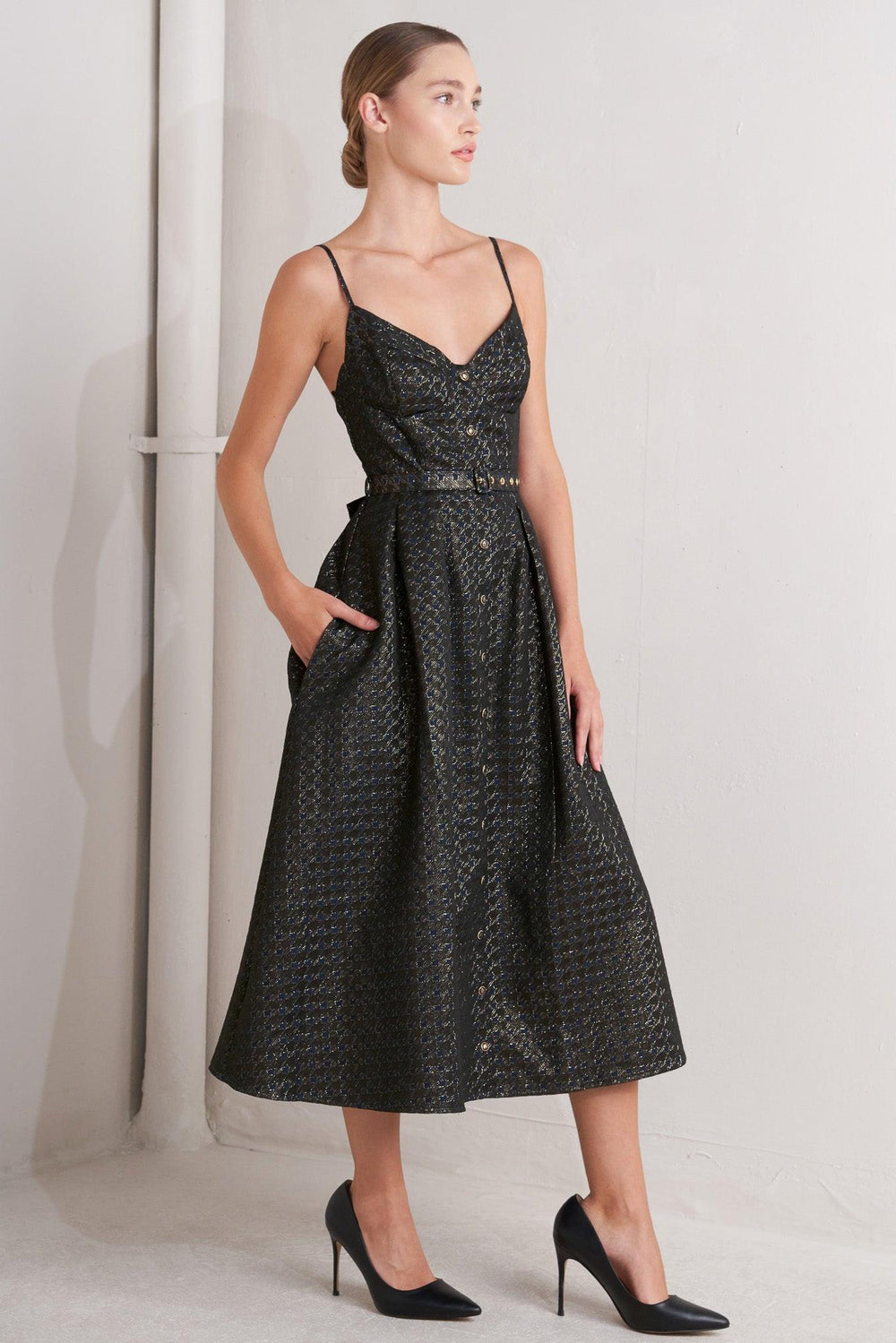A textured woven midi dress featuring cami top with straps, self belt, full skirt and front button down closure