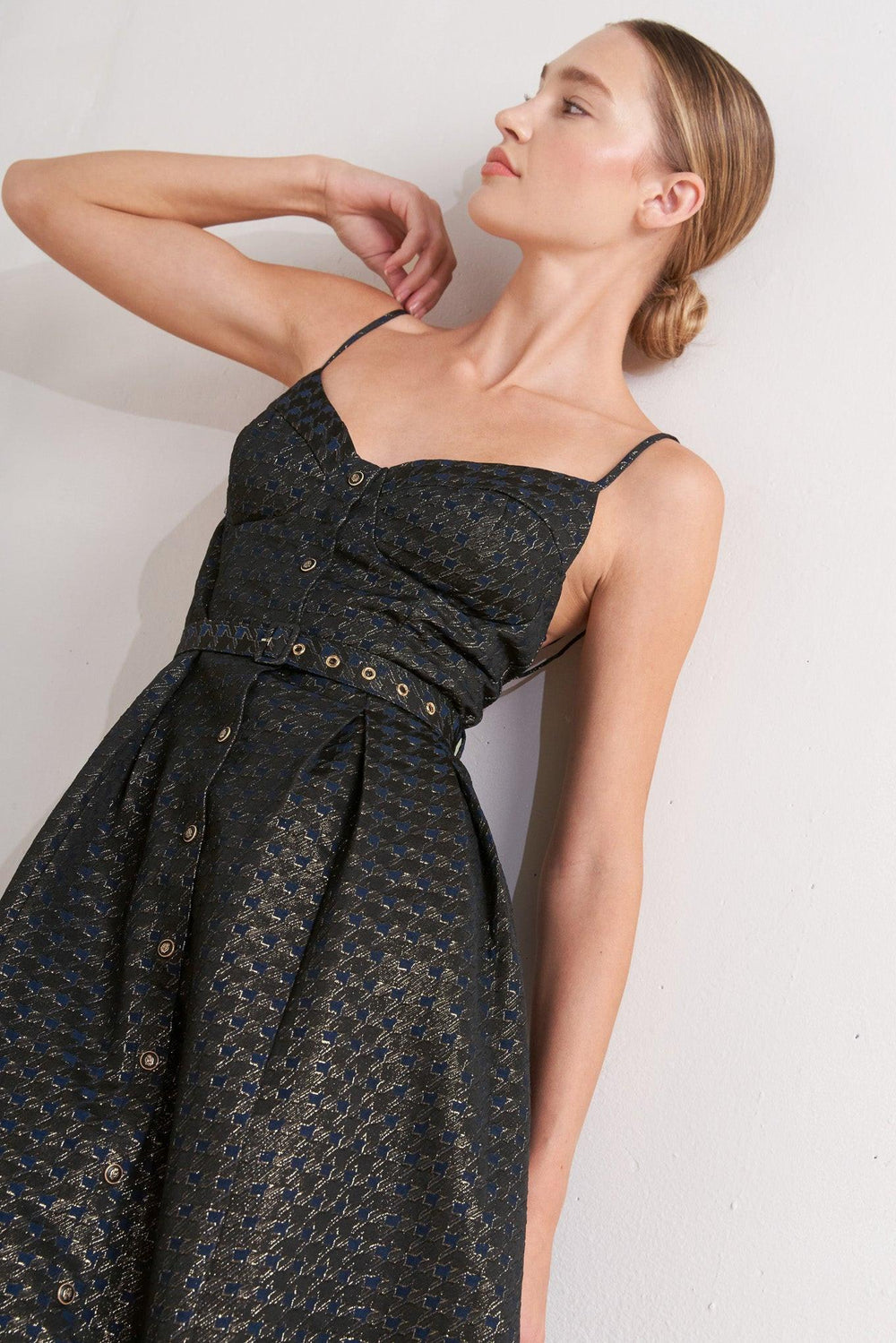 A textured woven midi dress featuring cami top with straps, self belt, full skirt and front button down closure