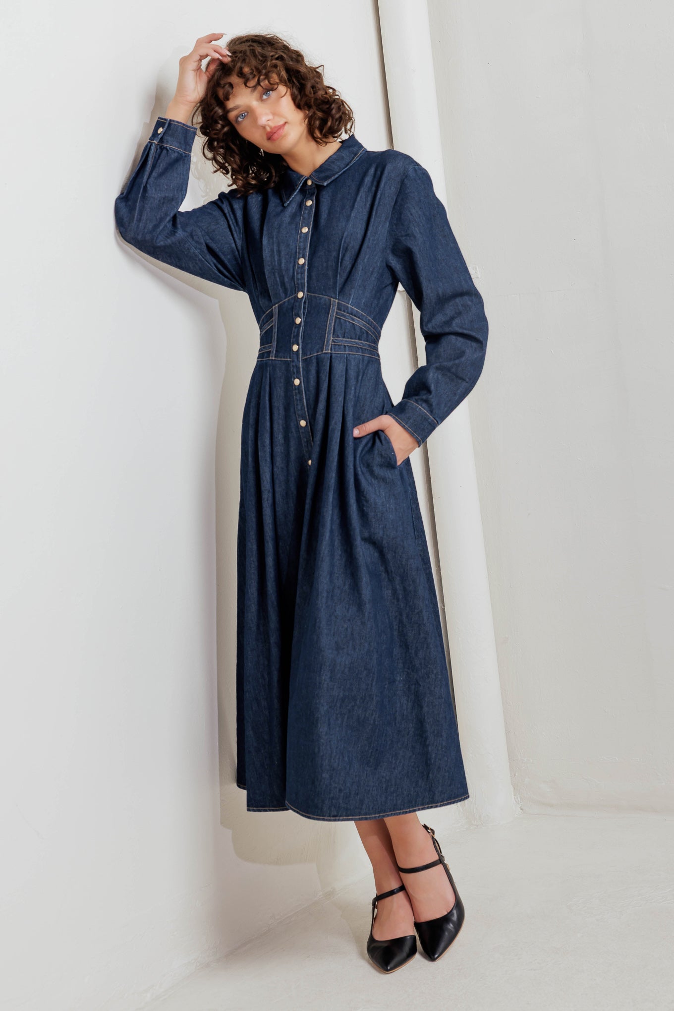 A denim midi dress featuring collar, front snap button closure, long sleeve, wide waist band and full skirt