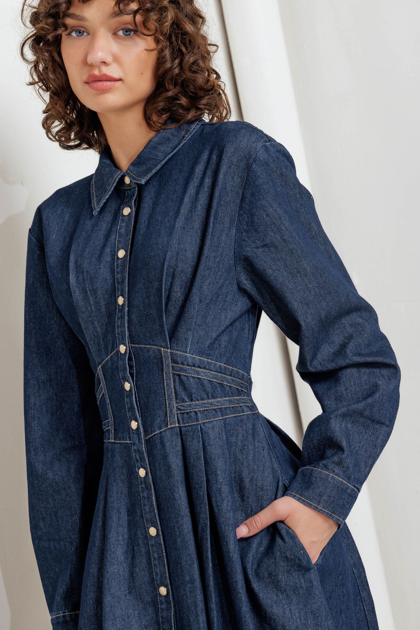 A denim midi dress featuring collar, front snap button closure, long sleeve, wide waist band and full skirt