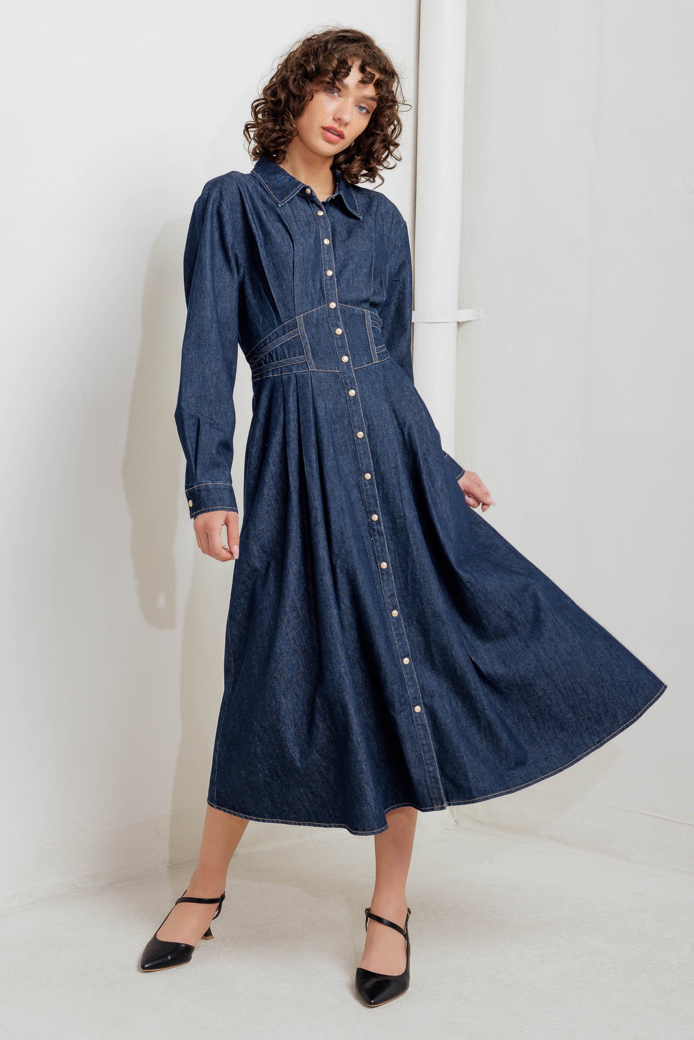 A denim midi dress featuring collar, front snap button closure, long sleeve, wide waist band and full skirt