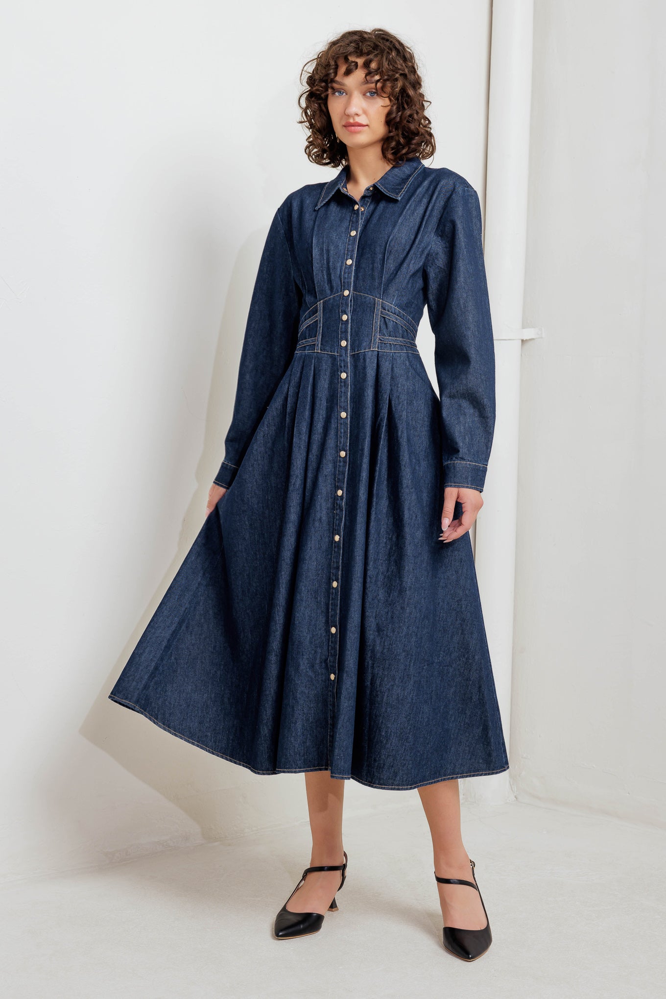 A denim midi dress featuring collar, front snap button closure, long sleeve, wide waist band and full skirt