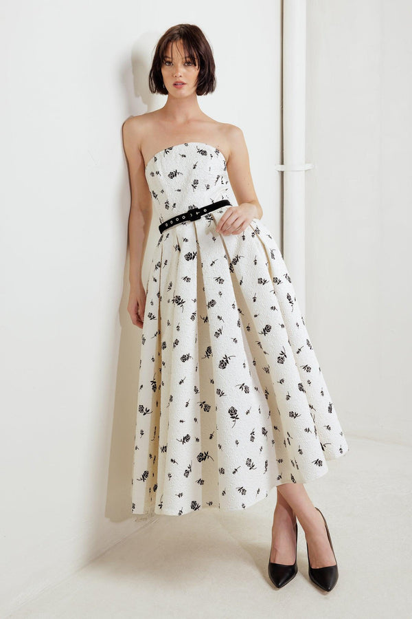 A printed textured woven midi dress featuring strapless neckline, contrasting belt, full skirt and back zipper closure