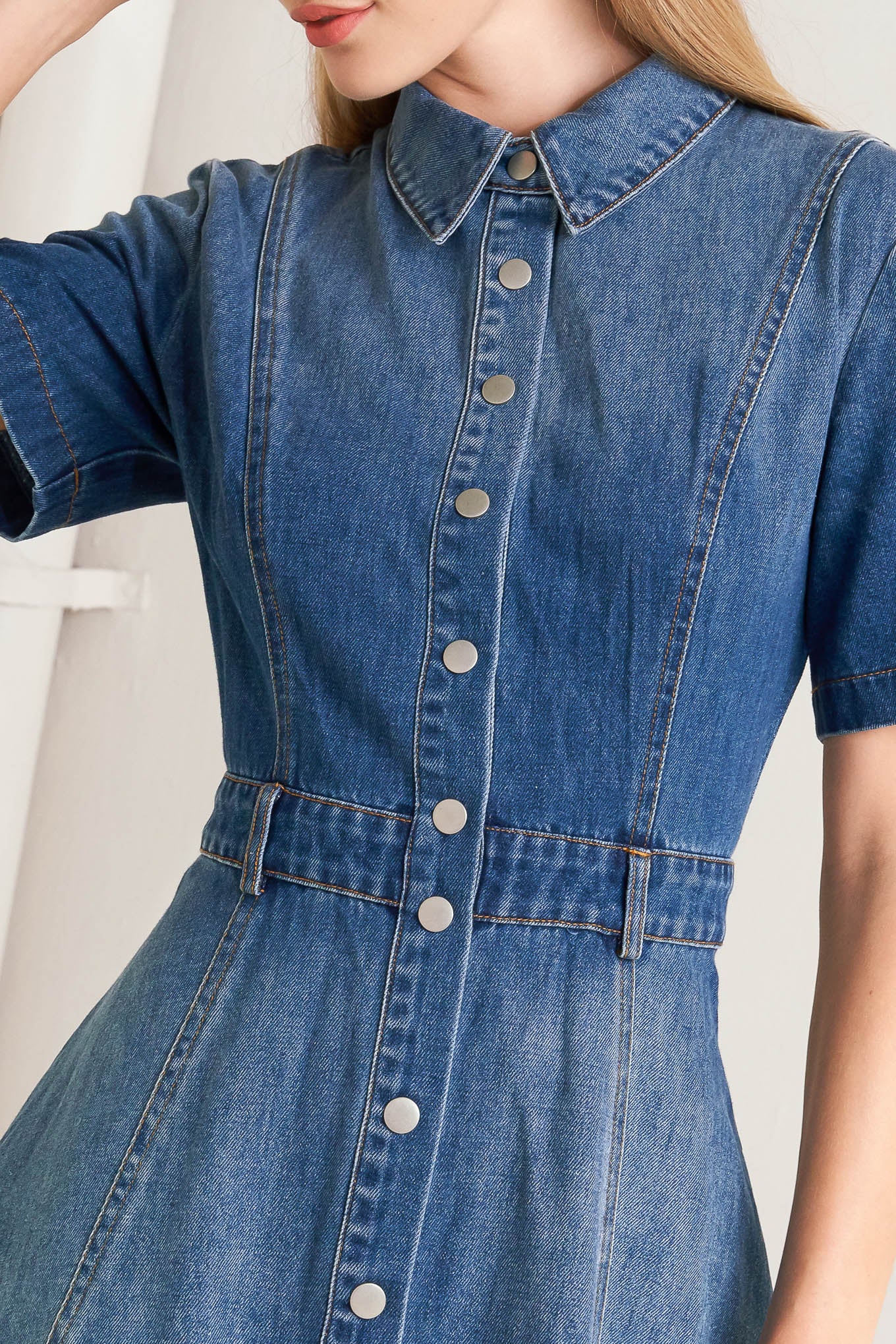 A washed denim midi dress featuring collar, snap button down, short sleeve and circle skirt