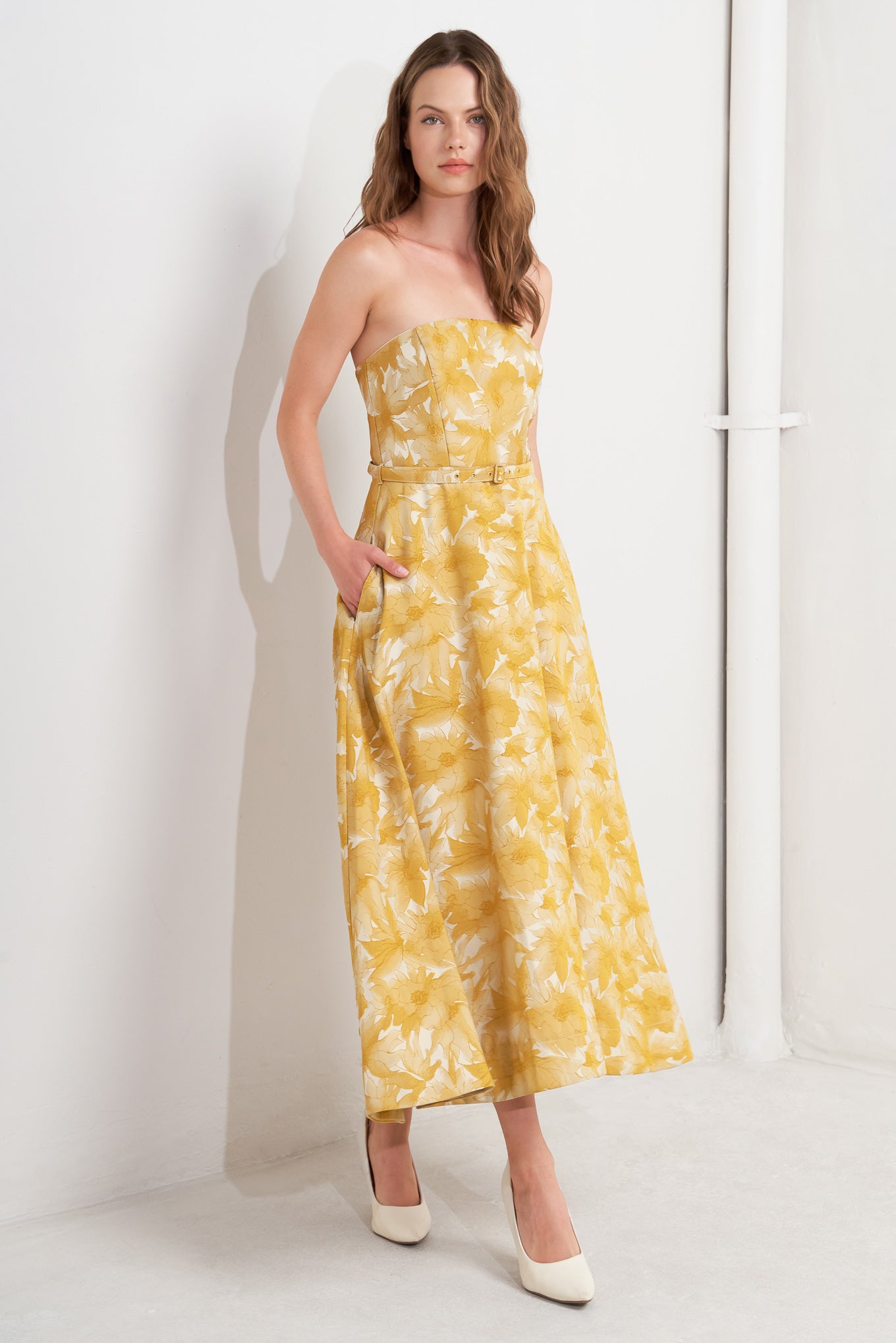 A woven jacquard midi dress featuring strapless, self belt, circle skirt and back zipper closure