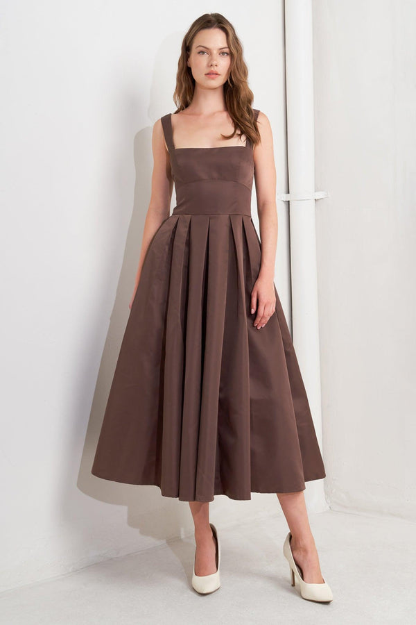 A solid woven midi dress featuring straight neckline, straps, full skirt, low back and zipper closure