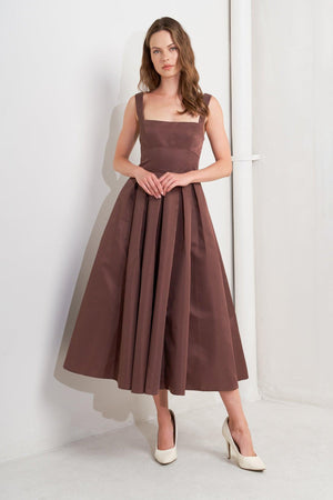 A solid woven midi dress featuring straight neckline, straps, full skirt, low back and zipper closure