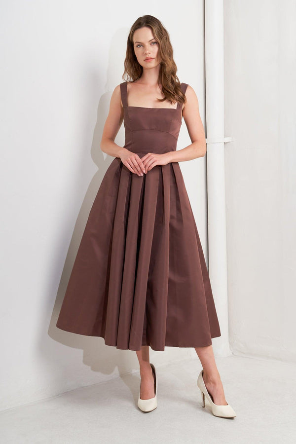 A solid woven midi dress featuring straight neckline, straps, full skirt, low back and zipper closure