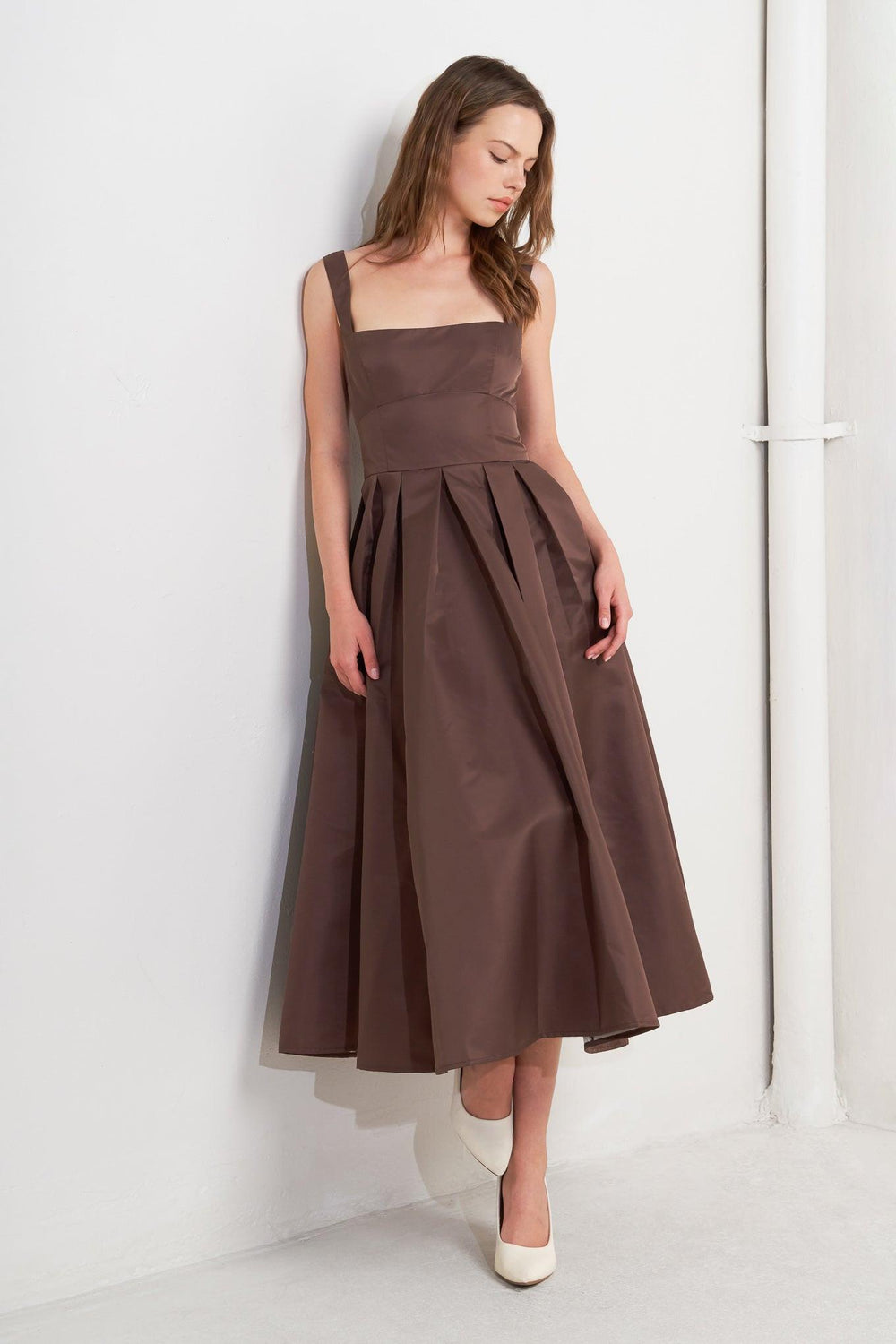 A solid woven midi dress featuring straight neckline, straps, full skirt, low back and zipper closure