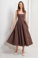 A solid woven midi dress featuring straight neckline, straps, full skirt, low back and zipper closure