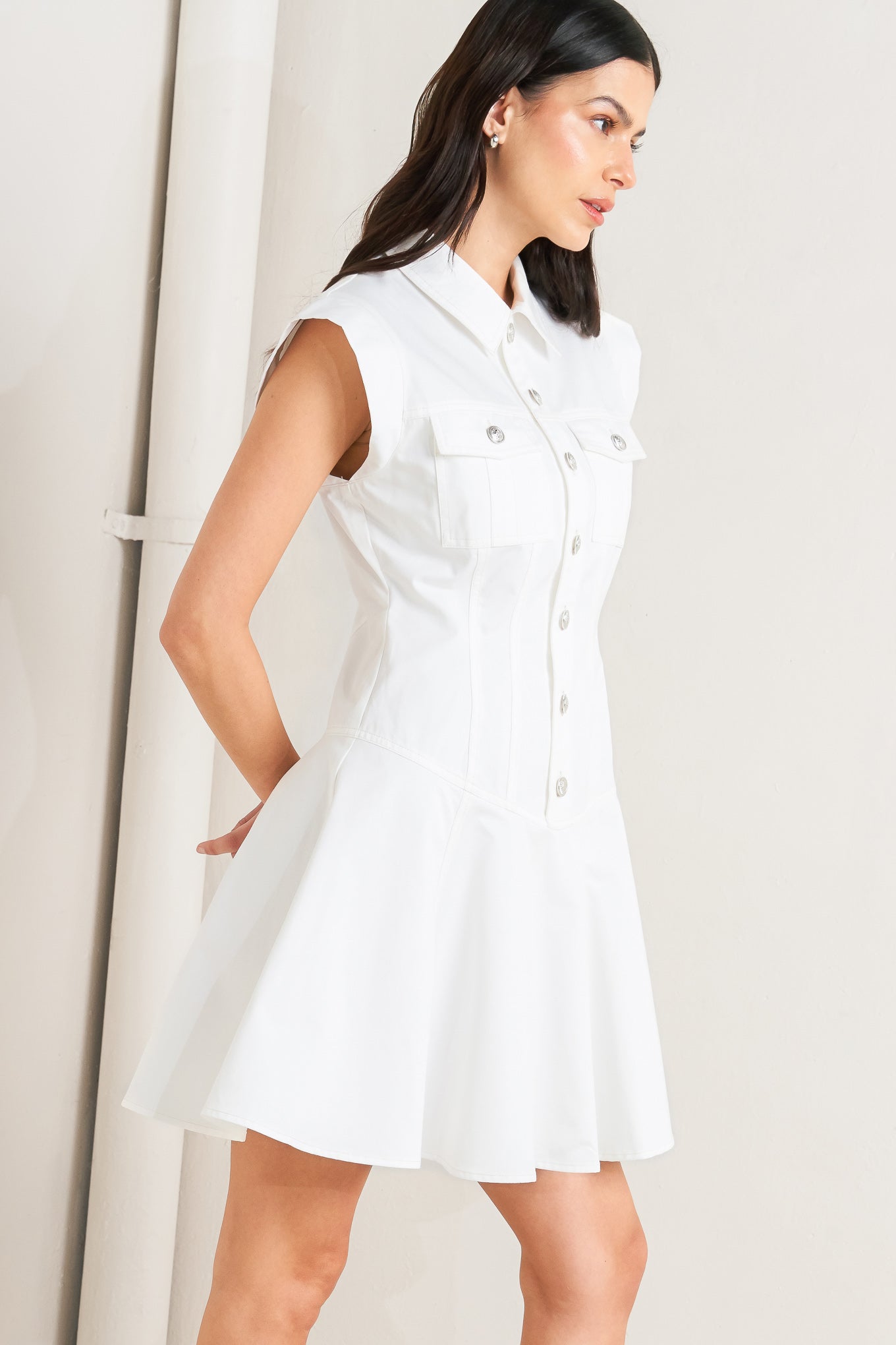 A solid woven mini dress featuring collar, short sleeve, front pocket, button down, drop waistline and circle skirt

Details:

Self: 100% Cotton

Size & Fit

- Model is 5`8" And Wearing Size Small
- Measurements Taken From Size Small
- Approx. Length: 34"