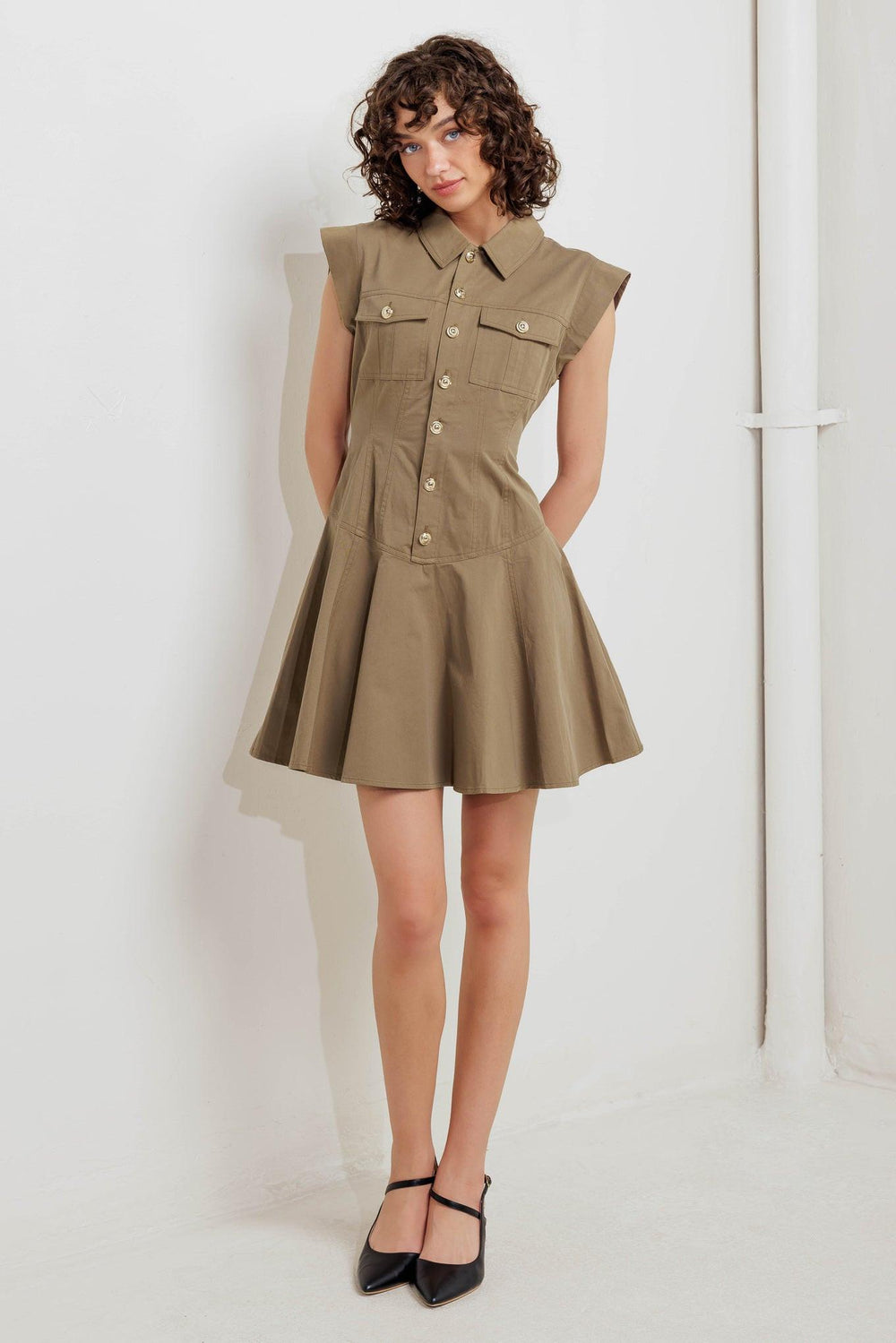 A solid woven mini dress featuring collar, short sleeve, front pocket, button down and circle skirt