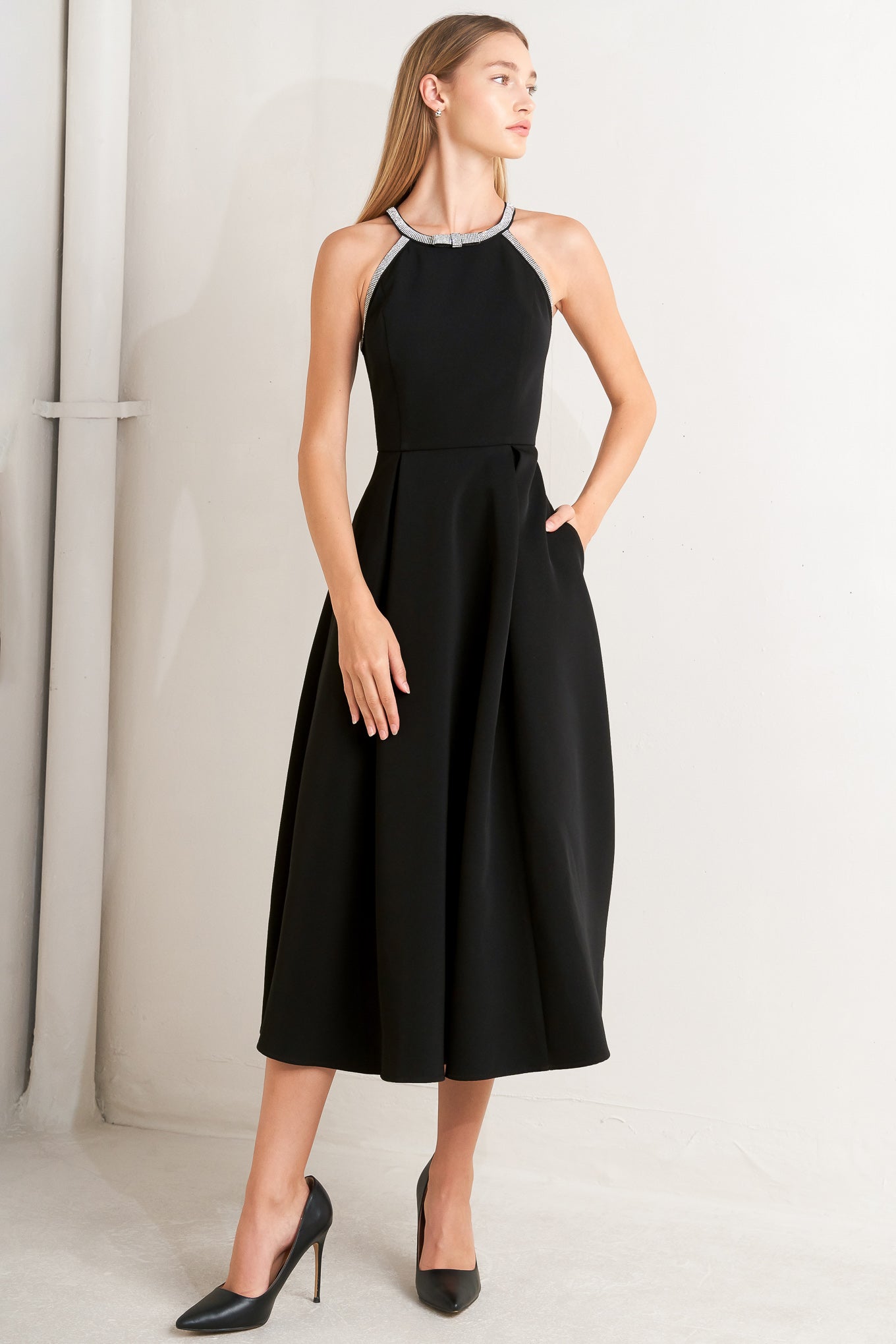 A solid woven midi dress featuring halter neckline with embellishment trim, full skirt and back zipper closure