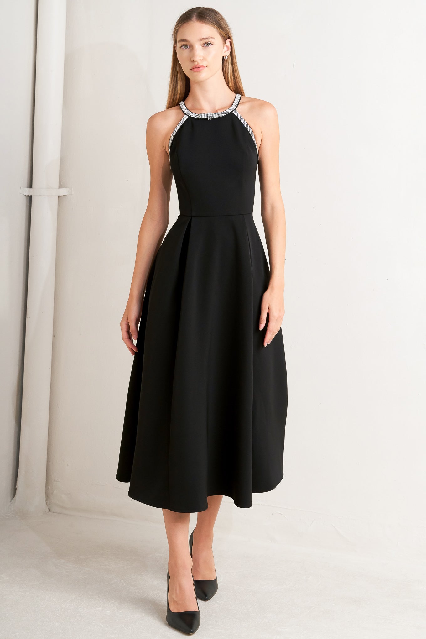 A solid woven midi dress featuring halter neckline with embellishment trim, full skirt and back zipper closure