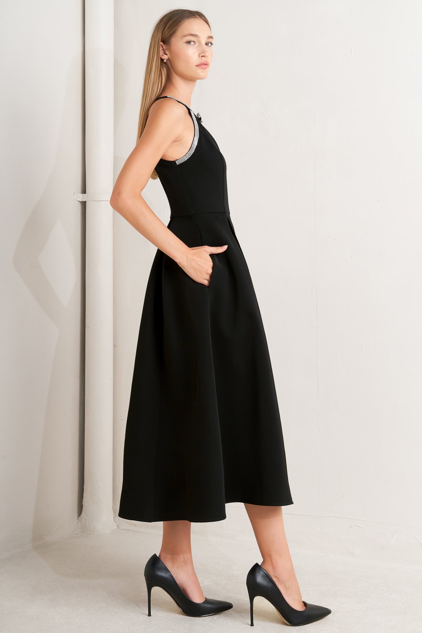 A solid woven midi dress featuring halter neckline with embellishment trim, full skirt and back zipper closure