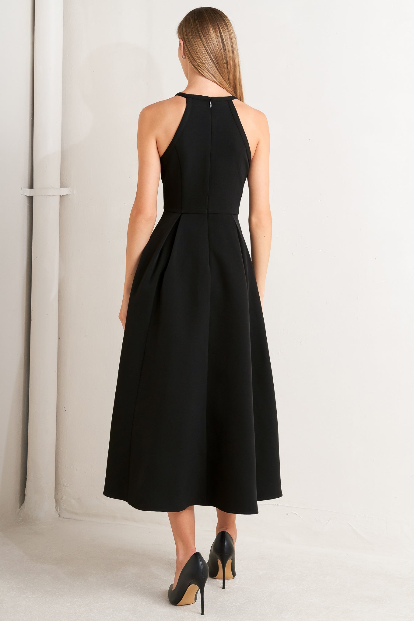A solid woven midi dress featuring halter neckline with embellishment trim, full skirt and back zipper closure
