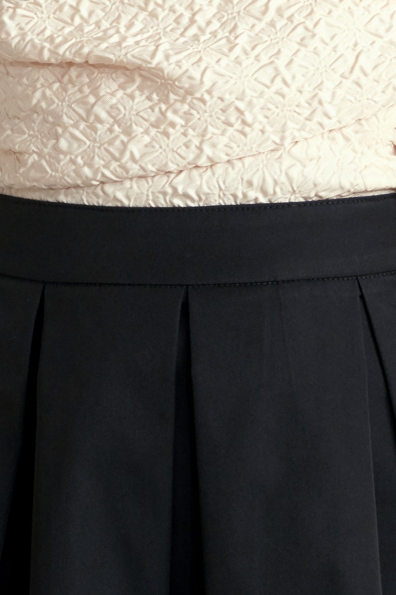 A solid woven midi dress featuring strapless textured woven bodice, full skirt and back zipper closure