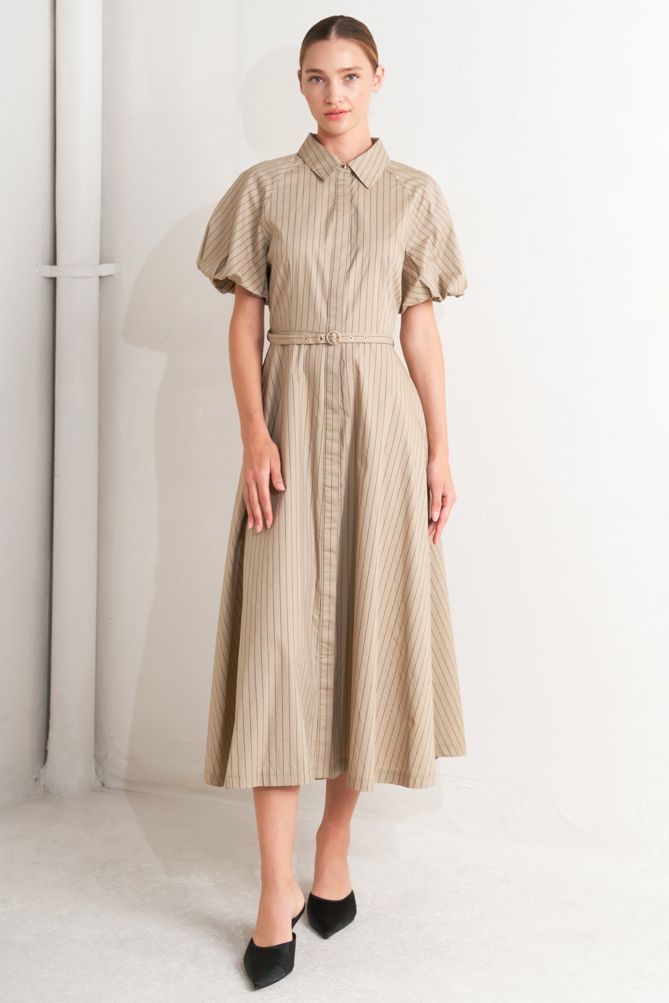 A striped woven midi dress featuring collar, raglan short puff sleeve, hidden button down, self belt and circle skirt