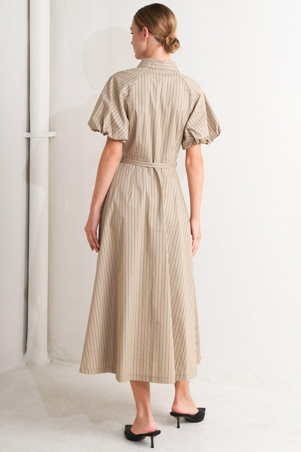 A striped woven midi dress featuring collar, raglan short puff sleeve, hidden button down, self belt and circle skirt