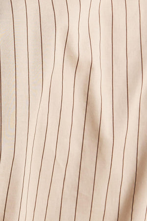 A striped woven midi dress featuring collar, raglan short puff sleeve, hidden button down, self belt and circle skirt
