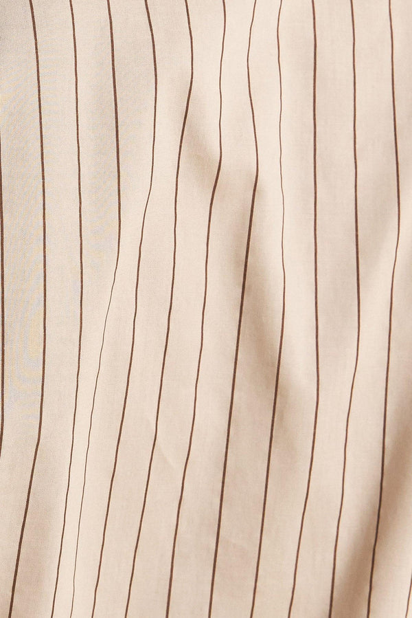 A striped woven midi dress featuring collar, raglan short puff sleeve, hidden button down, self belt and circle skirt