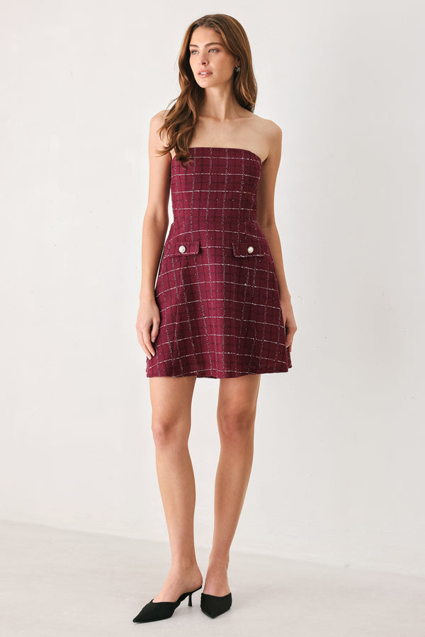 A woman modeling a strapless tube dress in a deep wine burgundy red plaid tweed fabric with white windowpane lines and two decorative buttons on the front | FREEMARKET