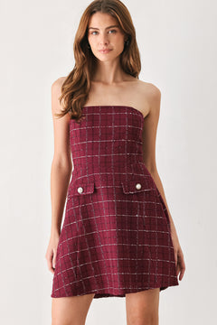 A woman modeling a strapless tube dress in a deep wine burgundy red plaid tweed fabric with white windowpane lines and two decorative buttons on the front | FREEMARKET