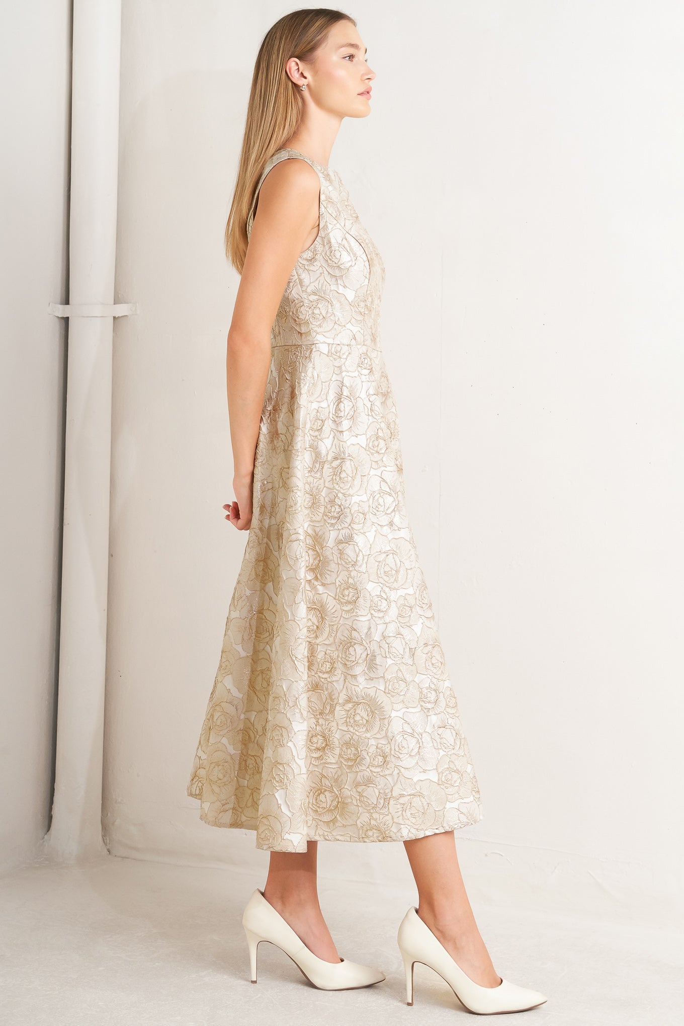 A textured woven midi dress featuring wide neckline, sleeveless, circle skirt and back zipper closure