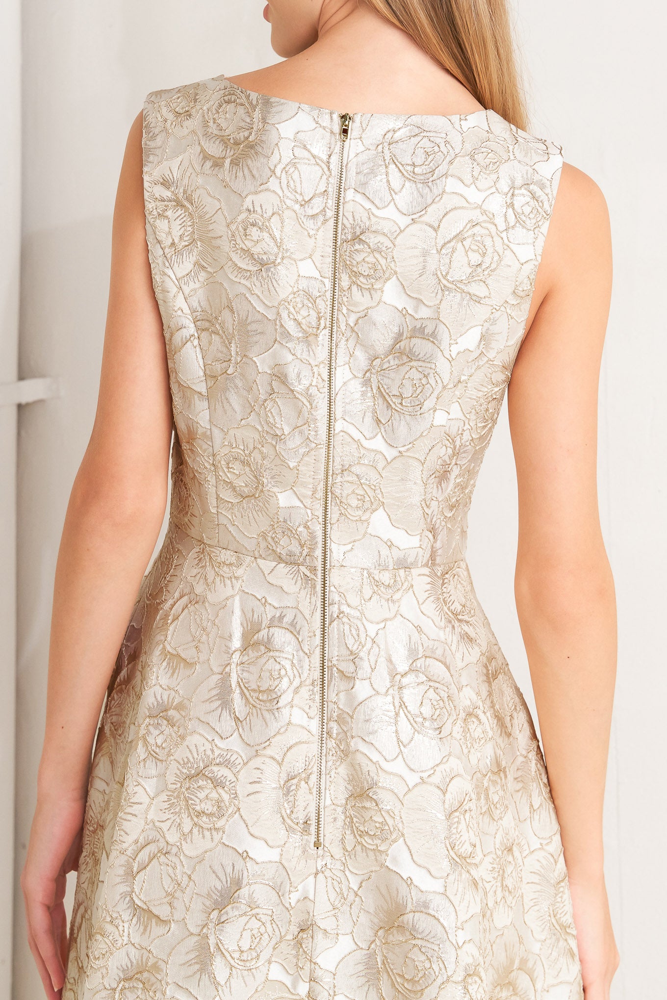 A textured woven midi dress featuring wide neckline, sleeveless, circle skirt and back zipper closure